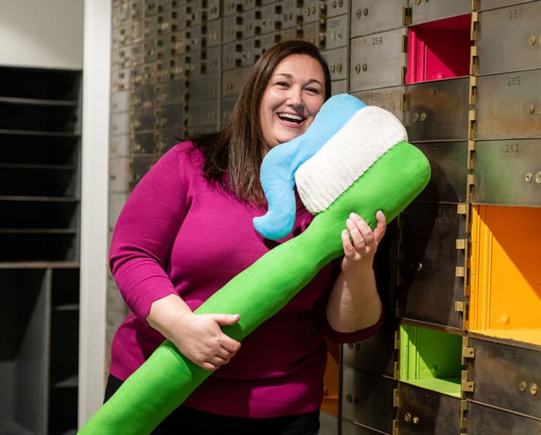 Dr. Lucia Gerstmann smiling with yoga mat