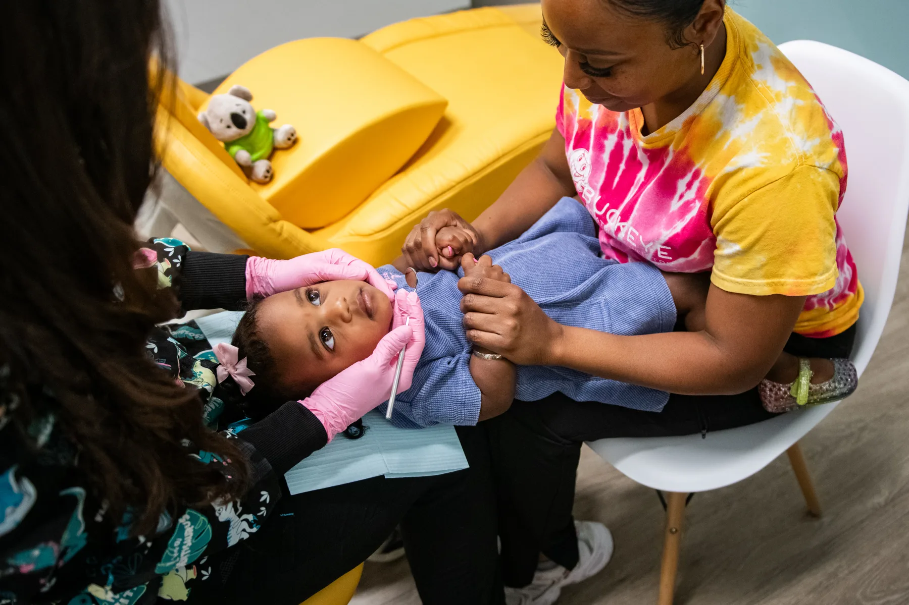 Knee-to-knee toddler dental exam at Buckeye Pediatric Dentistry