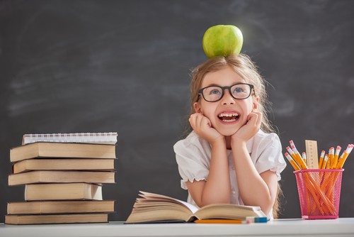 child at school with apple on her head
