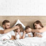 family in bed with sick kids -Buckeye Pediatric Dentistry in Reynoldsburg