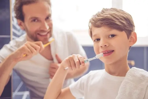 boy and father brushing teeth - Buckeye Pediatric Dentistry in Reynoldsburg