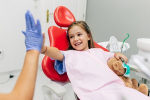 girl high fives hygienist