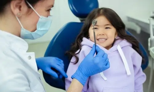 young girl at the dentist